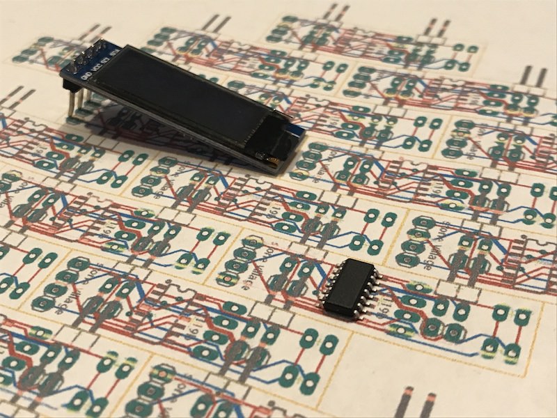 The tile PCB design printed and panelised, with a chip and OLED module on top